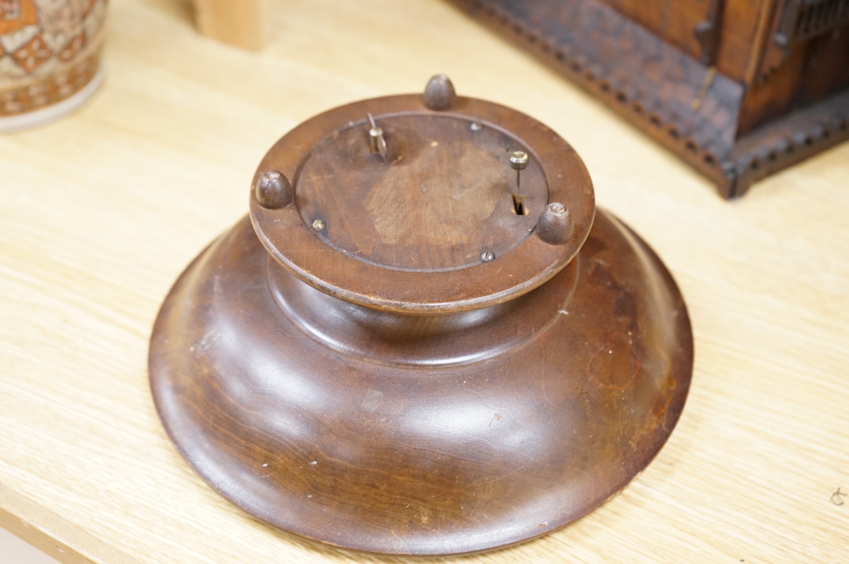 An early 20th century Black Forest carved walnut musical footed dish together with a model of a house (2)